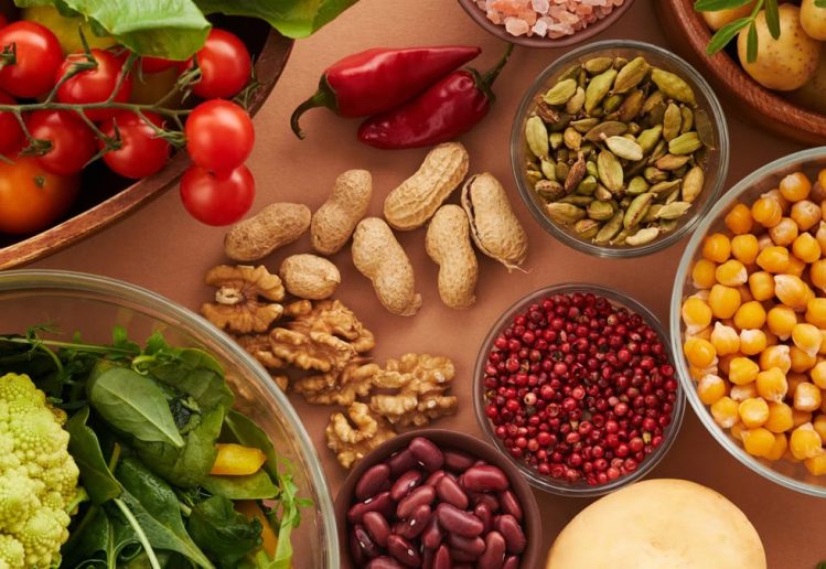 Explore a colorful assortment of healthy ingredients, featuring vegetables, nuts, seeds, and spices in a top view layout.